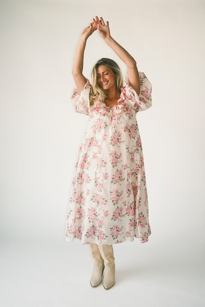 a pink floral puff sleeve dress with a ruffle neckline. the perfect vintage-inspired dress for baby showers, family pictures, + special occasions.