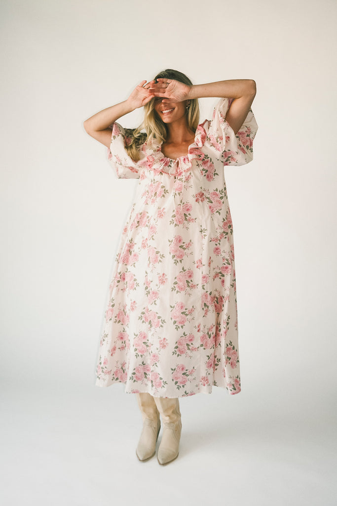a pink floral puff sleeve dress with a ruffle neckline. the perfect vintage-inspired dress for baby showers, family pictures, + special occasions.