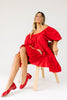zoco daymaker dress: a short puff sleeve dress with an elastic neckline. the perfect red cotton dress for family pictures, weddings, and baby showers.
