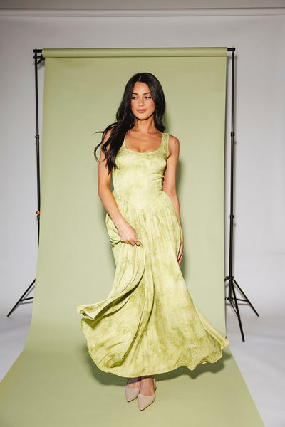 a flowy v-waist green dress with a sleek scoop neckline + subtle floral print. the perfect vintage-inspired maxi dress for weddings, bridal showers, + garden parties.
