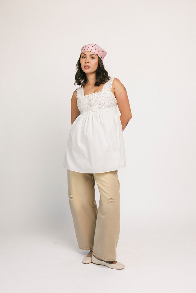 a white tank with a babydoll style silhouette + eyelet details. pair it with the matching white shorts to create the perfect two piece set for brunch dates, vacations, + everyday wear. 