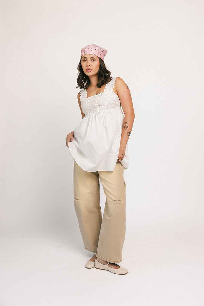 a white tank with a babydoll style silhouette + eyelet details. pair it with the matching white shorts to create the perfect two piece set for brunch dates, vacations, + everyday wear. 