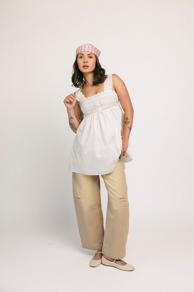 a white tank with a babydoll style silhouette + eyelet details. pair it with the matching white shorts to create the perfect two piece set for brunch dates, vacations, + everyday wear. 