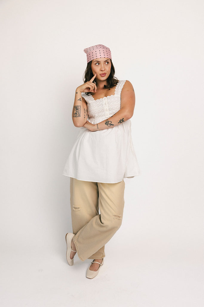 a white tank with a babydoll style silhouette + eyelet details. pair it with the matching white shorts to create the perfect two piece set for brunch dates, vacations, + everyday wear. 