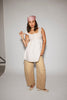 a white tank with a babydoll style silhouette + eyelet details. pair it with the matching white shorts to create the perfect two piece set for brunch dates, vacations, + everyday wear. 