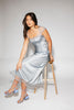 a light blue silk midi dress with lace detailing + a fitted silhouette. the perfect short sleeve occasion dress for weddings, bridal showers, + dinner parties.
