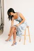 a light blue silk midi dress with lace detailing + a fitted silhouette. the perfect short sleeve occasion dress for weddings, bridal showers, + dinner parties.
