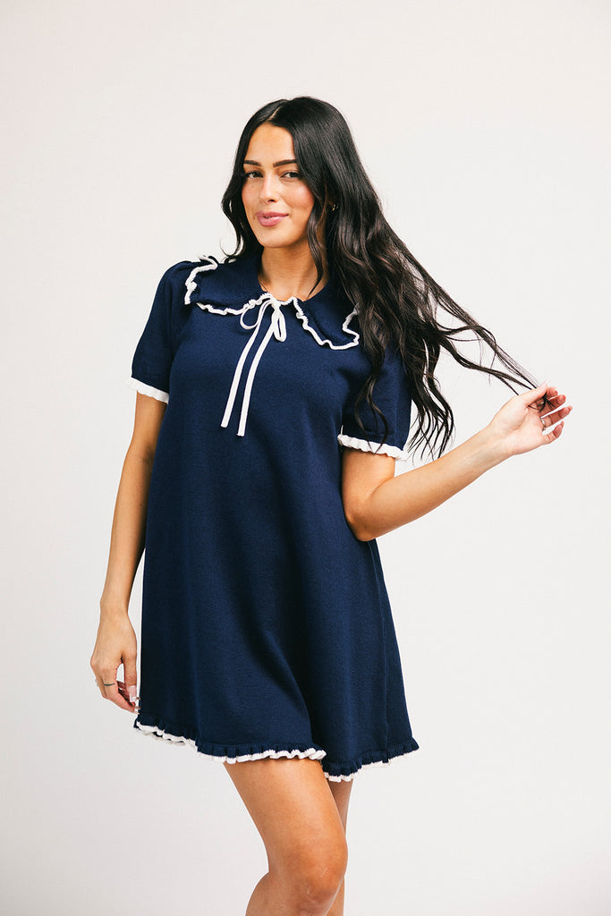 a short sleeve knit mini dress with a ruffled collar + bow detail. the perfect navy knit dress for date nights, family pictures, + everyday wear.
