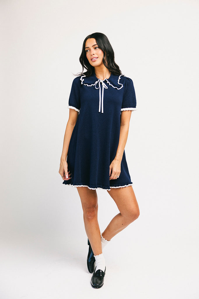 a short sleeve knit mini dress with a ruffled collar + bow detail. the perfect navy knit dress for date nights, family pictures, + everyday wear.
