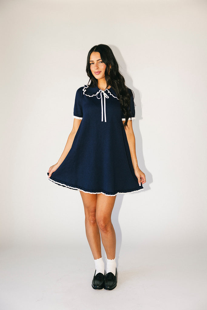 a short sleeve knit mini dress with a ruffled collar + bow detail. the perfect navy knit dress for date nights, family pictures, + everyday wear.
