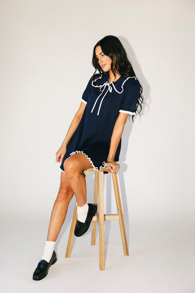 a short sleeve knit mini dress with a ruffled collar + bow detail. the perfect navy knit dress for date nights, family pictures, + everyday wear.
