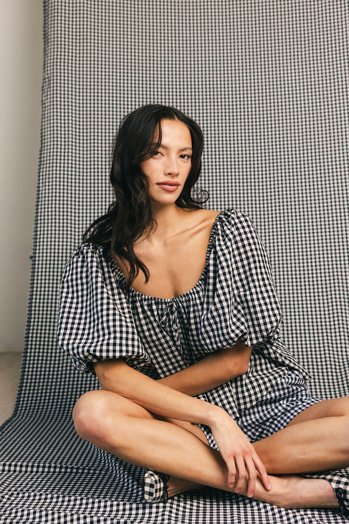 black and white gingham puff sleeve top with an elastic neckline + bow detail. the perfect elevated basic top for date nights + casual outfits. 