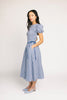 a puff sleeve blue gingham dress with a smocked bodice + side tie details. the perfect vintage-inspired dress for family pictures, weddings, + special occasions. 
