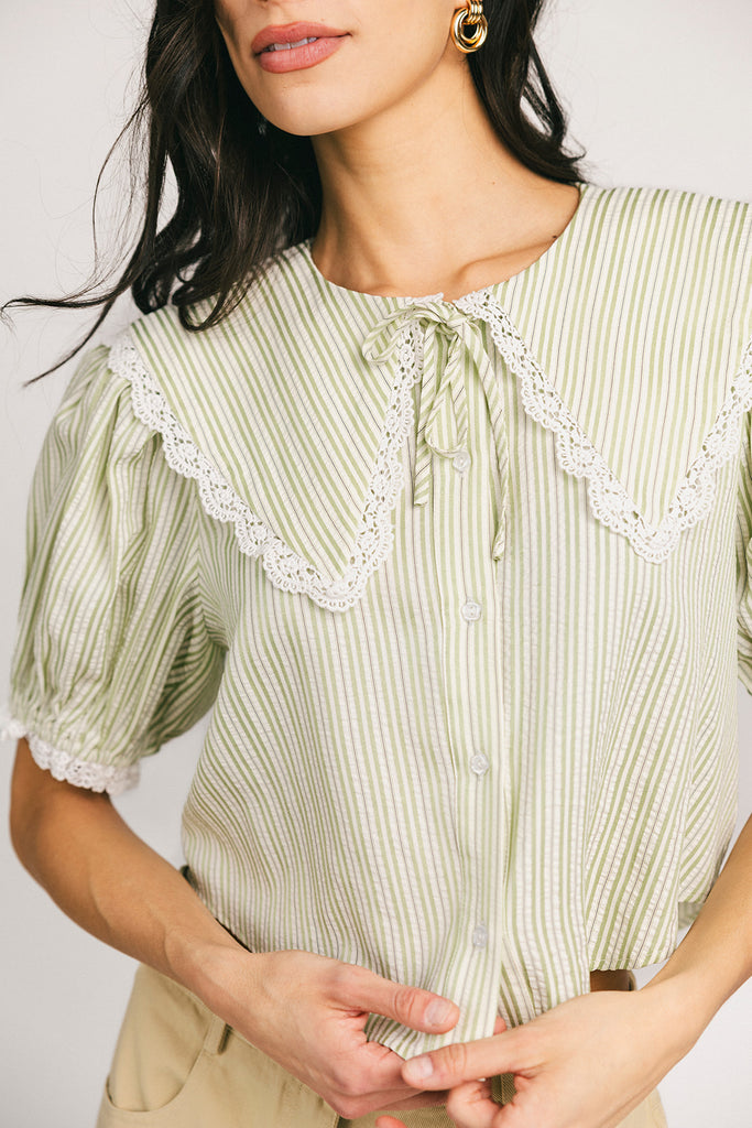 a vintage-inspired puff sleeve top with a pastel green pinstripe pattern + an oversized lace trim collar. the perfect elevated button up top for the office, dressy date nights, + everyday wear.
