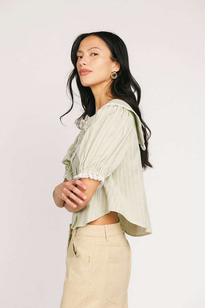 a vintage-inspired puff sleeve top with a pastel green pinstripe pattern + an oversized lace trim collar. the perfect elevated button up top for the office, dressy date nights, + everyday wear.
