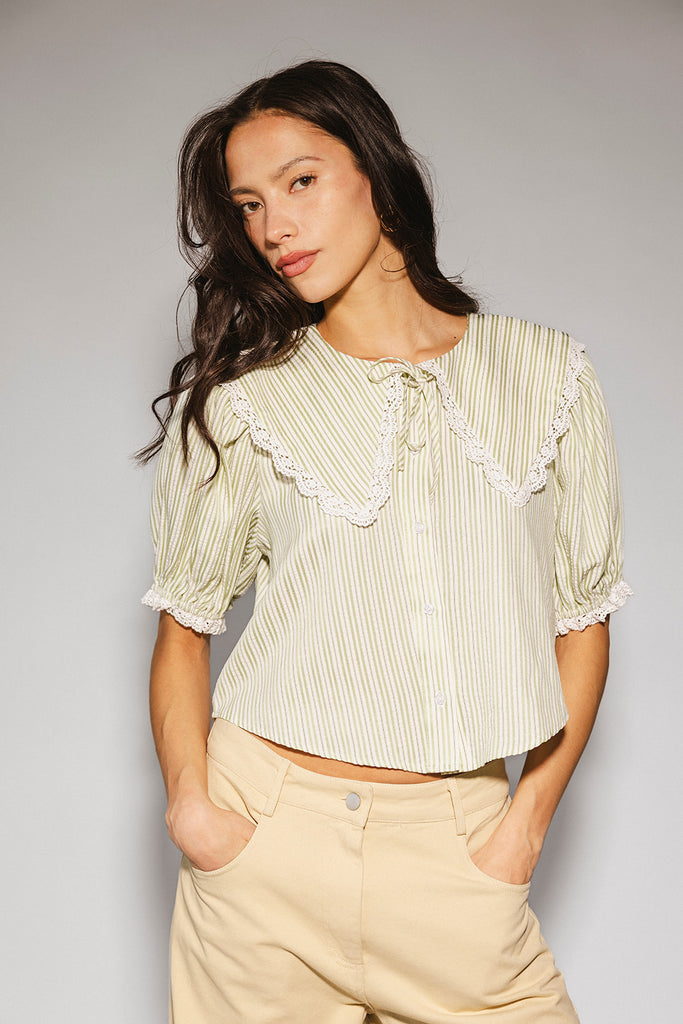 a vintage-inspired puff sleeve top with a pastel green pinstripe pattern + an oversized lace trim collar. the perfect elevated button up top for the office, dressy date nights, + everyday wear.
