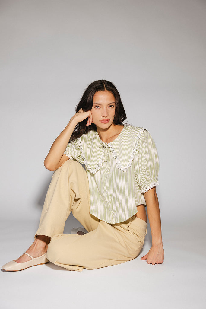 a vintage-inspired puff sleeve top with a pastel green pinstripe pattern + an oversized lace trim collar. the perfect elevated button up top for the office, dressy date nights, + everyday wear.
