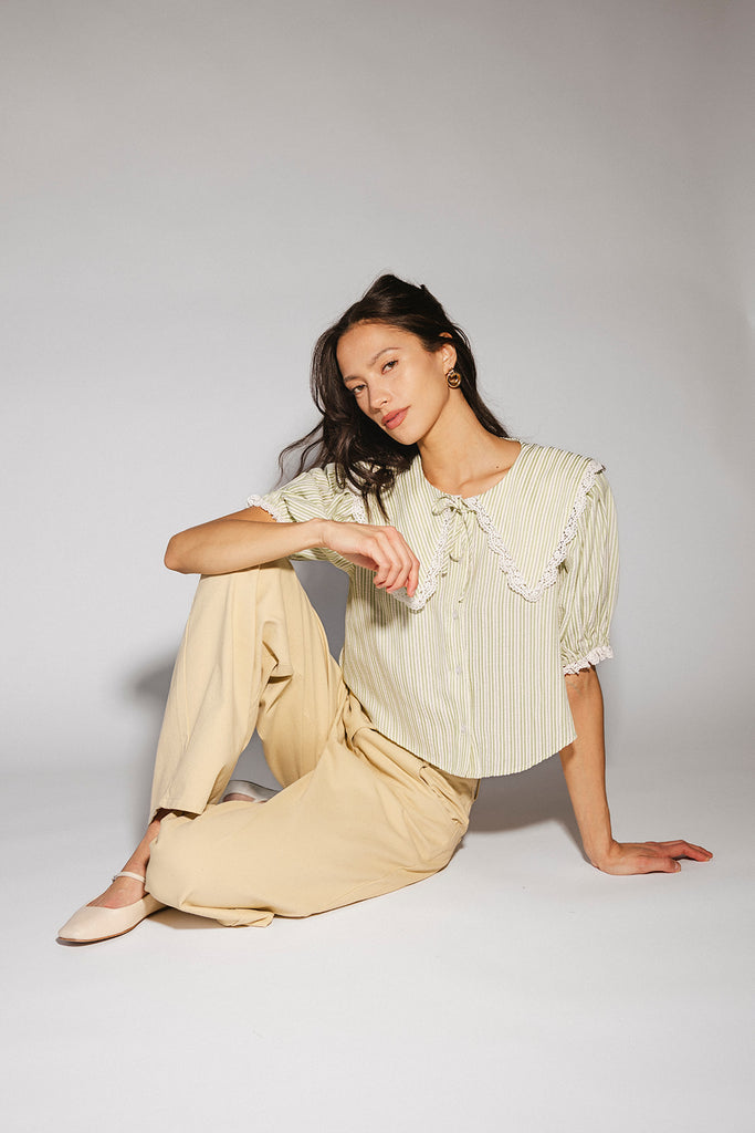 a vintage-inspired puff sleeve top with a pastel green pinstripe pattern + an oversized lace trim collar. the perfect elevated button up top for the office, dressy date nights, + everyday wear.
