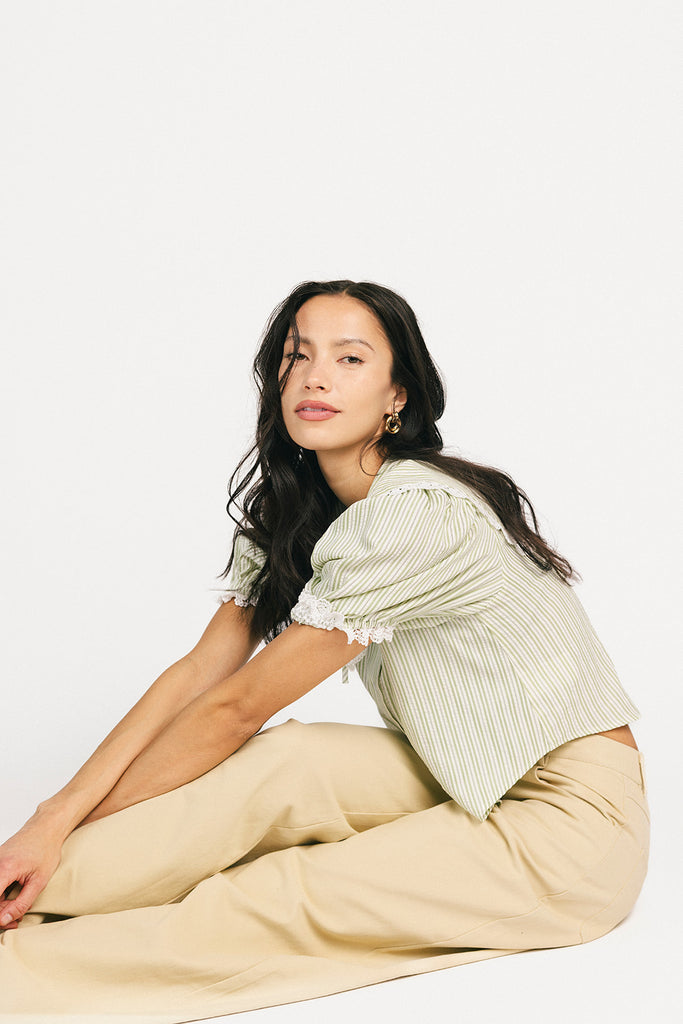 a vintage-inspired puff sleeve top with a pastel green pinstripe pattern + an oversized lace trim collar. the perfect elevated button up top for the office, dressy date nights, + everyday wear.
