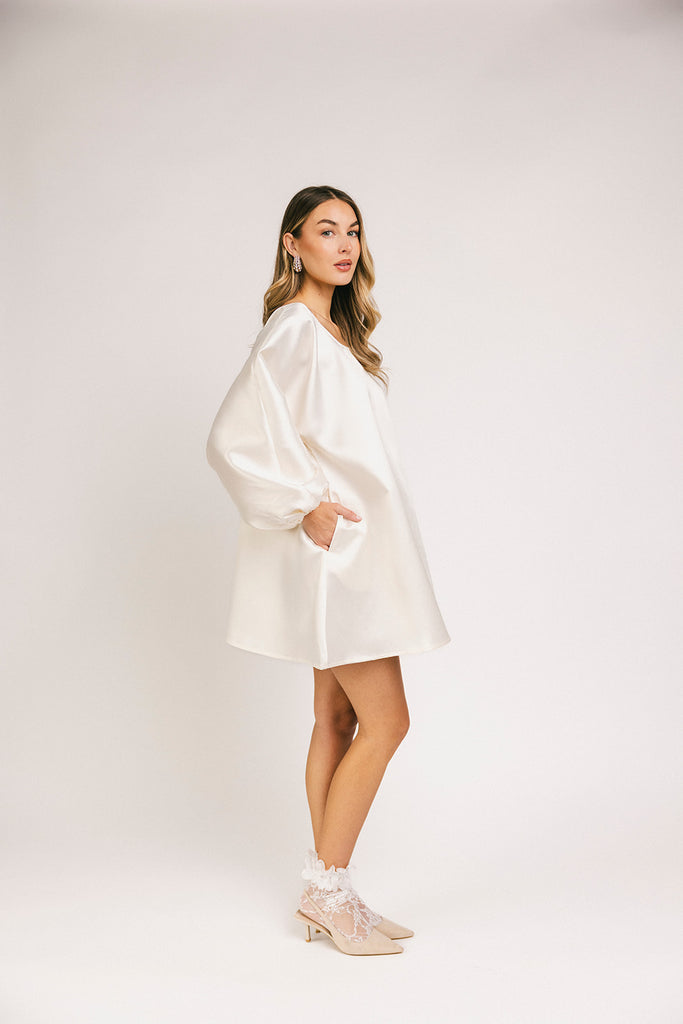 a white satin mini dress with a vintage-inspired silhouette + long balloon sleeves. the perfect little white dress for graduations, bridal showers, + fancy dinner dates.
