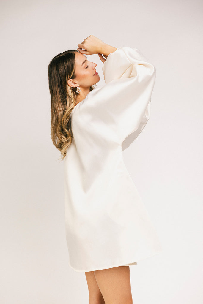 a white satin mini dress with a vintage-inspired silhouette + long balloon sleeves. the perfect little white dress for graduations, bridal showers, + fancy dinner dates.
