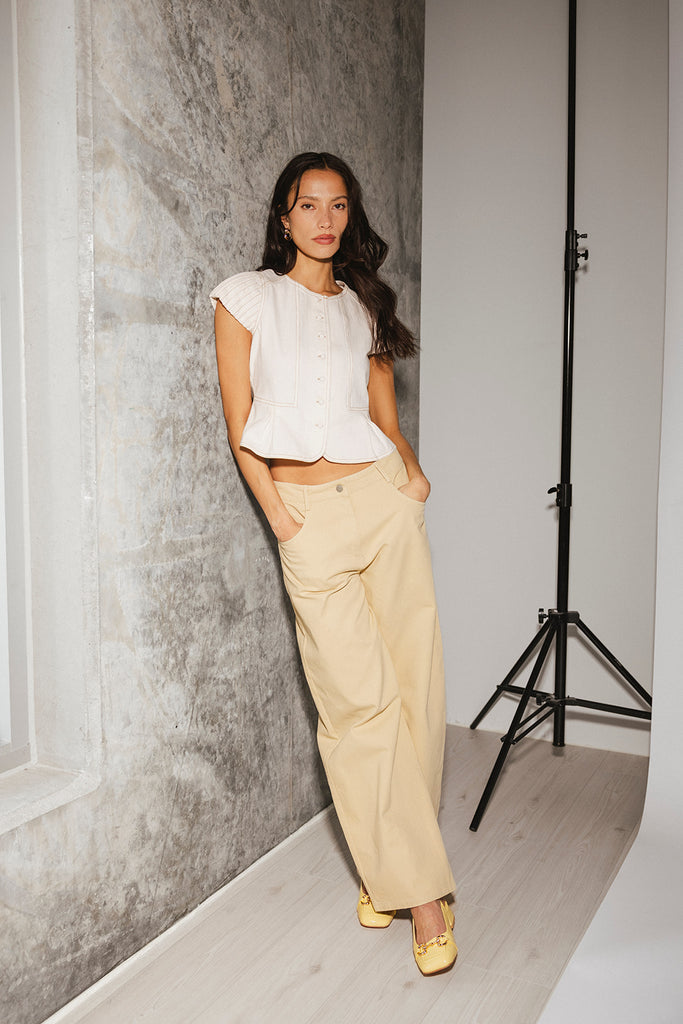 a white denim short sleeve top with a fitted silhouette + a peplum hemline. the perfect denim top to dress up or down for any outfit idea.
