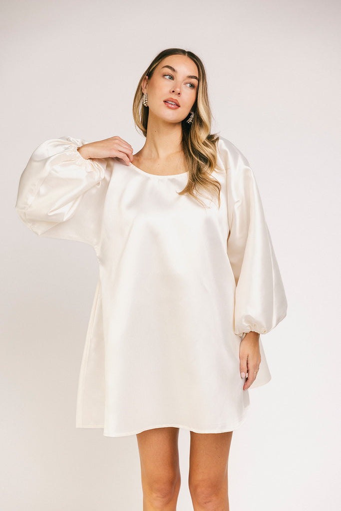 a white satin mini dress with a vintage-inspired silhouette + long balloon sleeves. the perfect little white dress for graduations, bridal showers, + fancy dinner dates.

