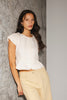 a white denim short sleeve top with a fitted silhouette + a peplum hemline. the perfect denim top to dress up or down for any outfit idea.
