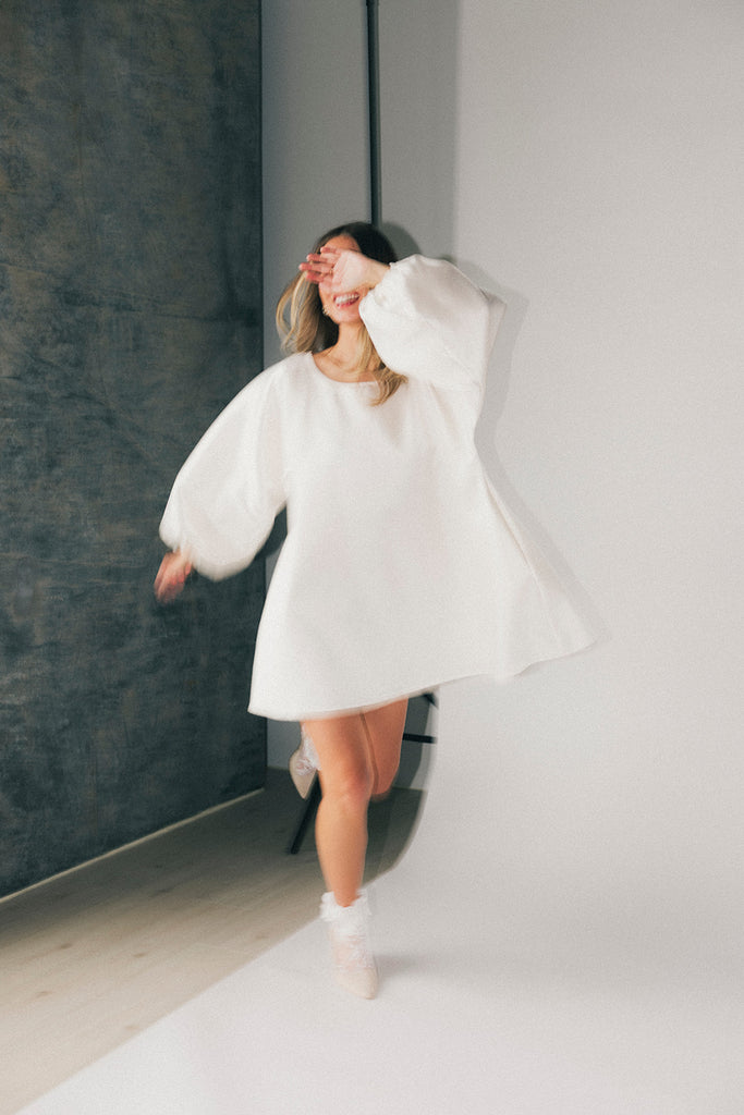 a white satin mini dress with a vintage-inspired silhouette + long balloon sleeves. the perfect little white dress for graduations, bridal showers, + fancy dinner dates.
