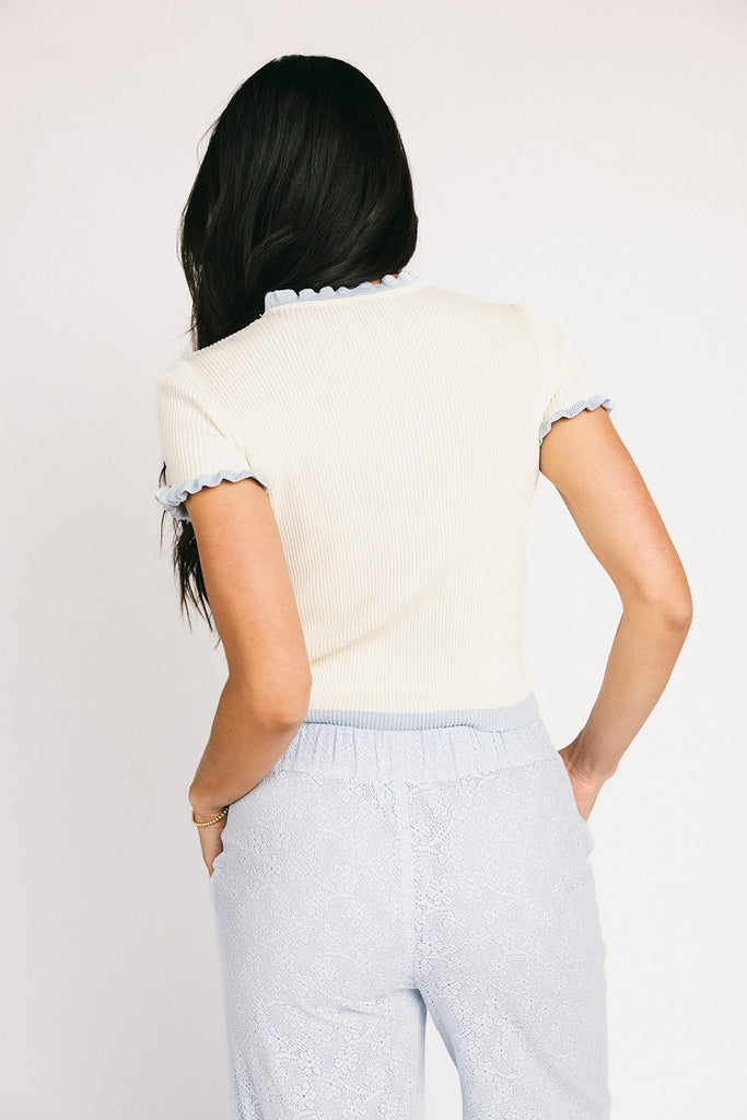 vintage-inspired short sleeve fitted top with blue ruffle details. the perfect elevated basic to dress up or down for any outfit idea.
