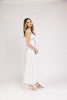 a white satin midi dress with lace detailing + a fitted silhouette. the perfect short sleeve occasion dress for weddings, bridal showers, + dinner parties.
