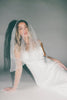 a white satin midi dress with lace detailing + a fitted silhouette. the perfect short sleeve occasion dress for weddings, bridal showers, + dinner parties.
