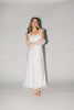 a white satin midi dress with lace detailing + a fitted silhouette. the perfect short sleeve occasion dress for weddings, bridal showers, + dinner parties.
