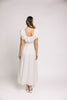 a white vintage-inspired midi dress with a lace ruffle neckline + bow detail. the perfect white dress for bridal showers, rehearsal dinners, + any special occasion.

