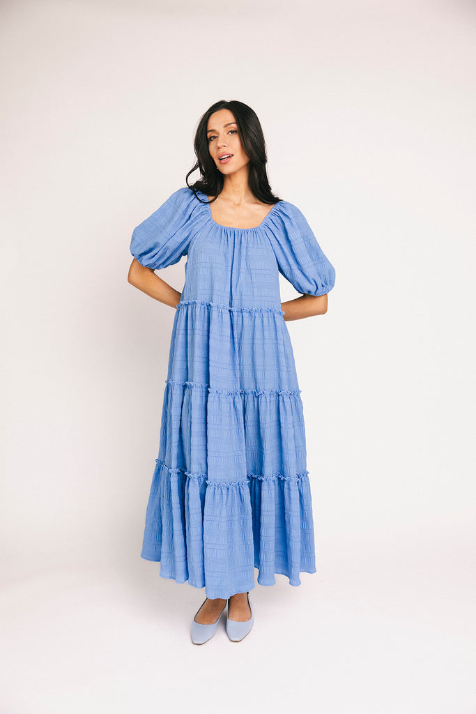 zoco daymaker dress: puff sleeve blue maxi dress with an elastic neckline. perfect for weddings, baby showers, and family pictures.

