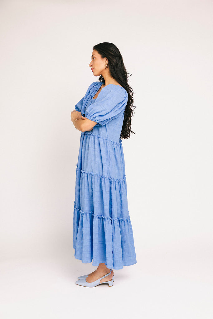 zoco daymaker dress: puff sleeve blue maxi dress with an elastic neckline. perfect for weddings, baby showers, and family pictures.
