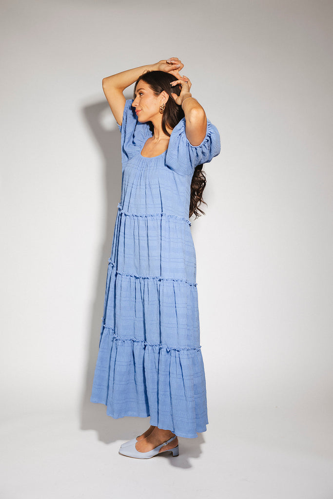 zoco daymaker dress: puff sleeve blue maxi dress with an elastic neckline. perfect for weddings, baby showers, and family pictures.

