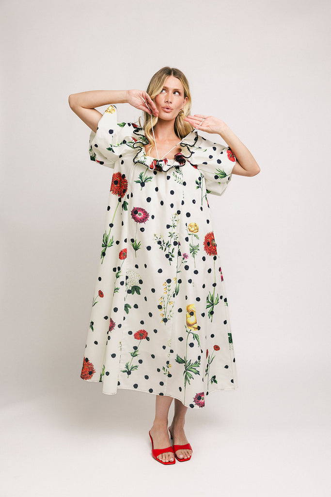 a polka dot puff sleeve dress with floral print details. the perfect polka dot midi dress for baby showers, family pictures, + special occasions. 

