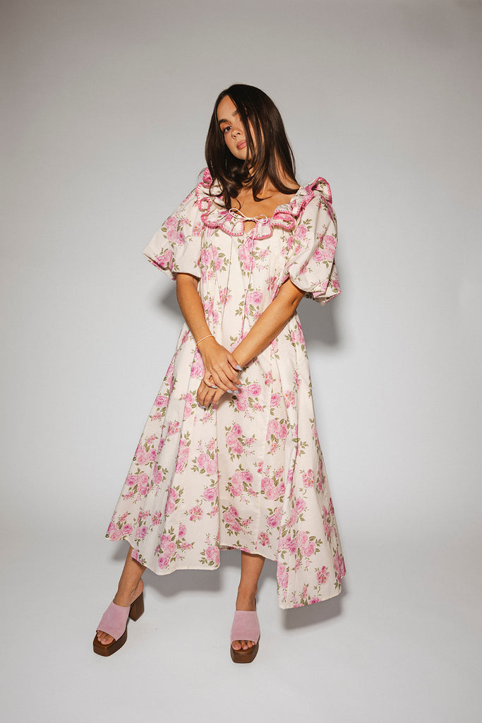 a pink floral puff sleeve dress with a ruffle neckline. the perfect vintage-inspired dress for baby showers, family pictures, + special occasions.
