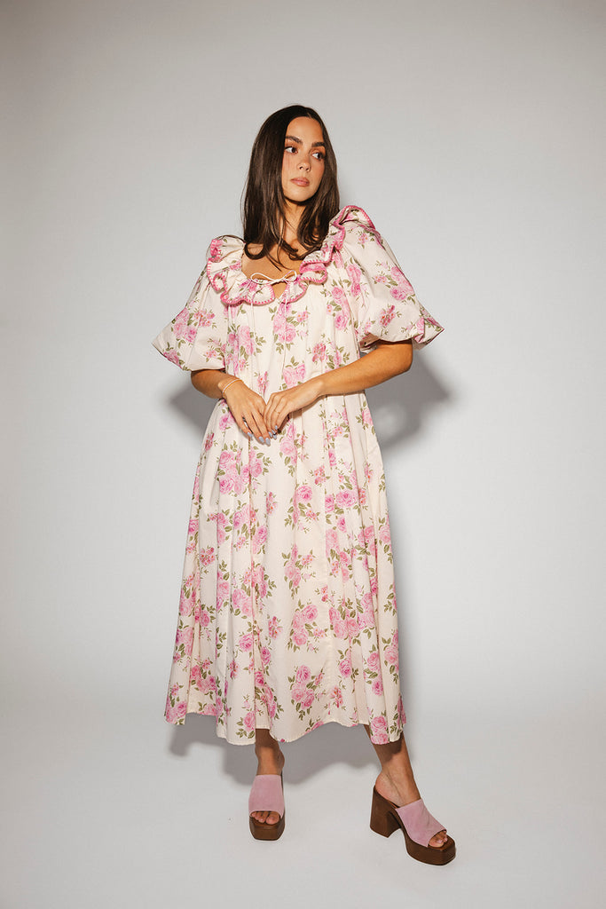 a pink floral puff sleeve dress with a ruffle neckline. the perfect vintage-inspired dress for baby showers, family pictures, + special occasions.
