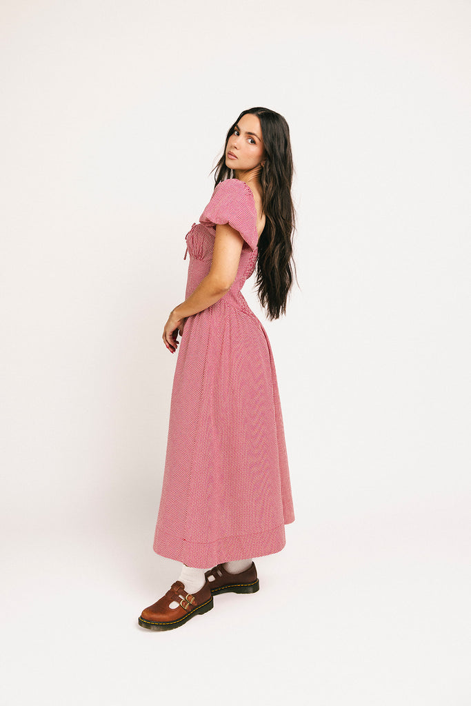 vintage-inspired puff sleeve dress with a square neckline. the perfect red gingham puff sleeve dress for rodeos, family pictures,+ semi-casual occasions.
