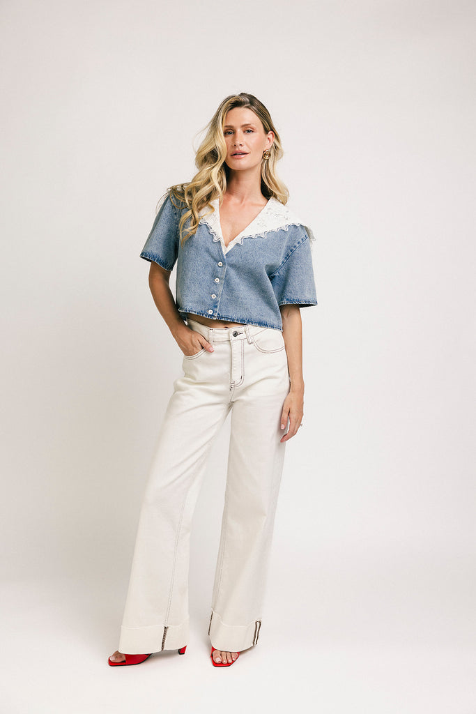 a short sleeve denim top with an oversized lace collar + a cropped silhouette. the perfect button up denim top to dress up or down for any outfit idea.
