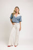 a short sleeve denim top with an oversized lace collar + a cropped silhouette. the perfect button up denim top to dress up or down for any outfit idea.
