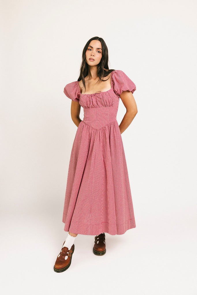 vintage-inspired puff sleeve dress with a square neckline. the perfect red gingham puff sleeve dress for rodeos, family pictures,+ semi-casual occasions.
