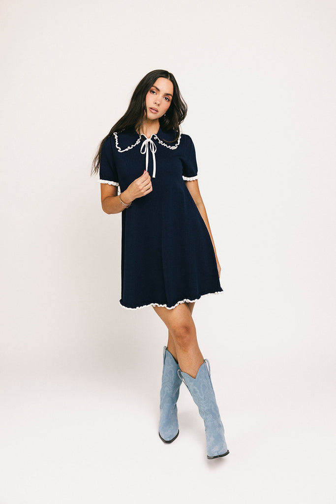 a short sleeve knit mini dress with a ruffled collar + bow detail. the perfect navy knit dress for date nights, family pictures, + everyday wear.

