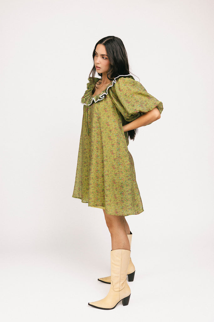 a green floral puff sleeve mini dress with a ruffle neckline. the perfect vintage-inspired dress for baby showers, family pictures, + special occasions. 
