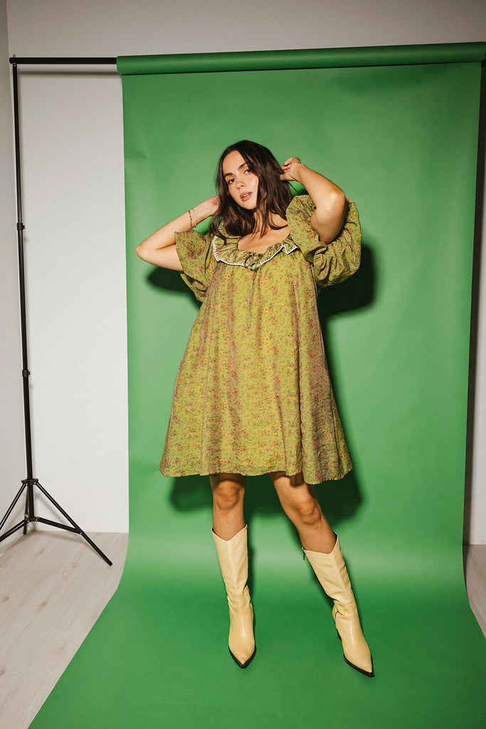 a green floral puff sleeve mini dress with a ruffle neckline. the perfect vintage-inspired dress for baby showers, family pictures, + special occasions. 
