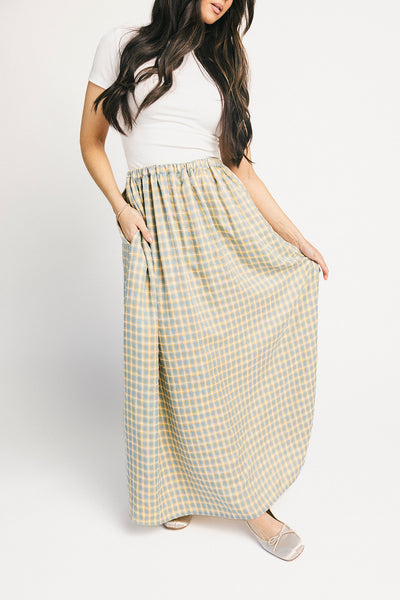 blue and yellow gingham maxi skirt with an elastic waist + side slit details. the perfect flowy gingham skirt to dress up or down for any outfit idea.
