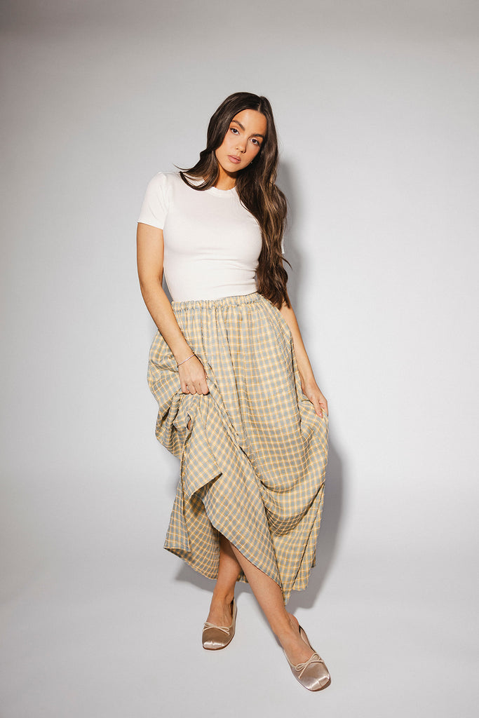 blue and yellow gingham maxi skirt with an elastic waist + side slit details. the perfect flowy gingham skirt to dress up or down for any outfit idea.
