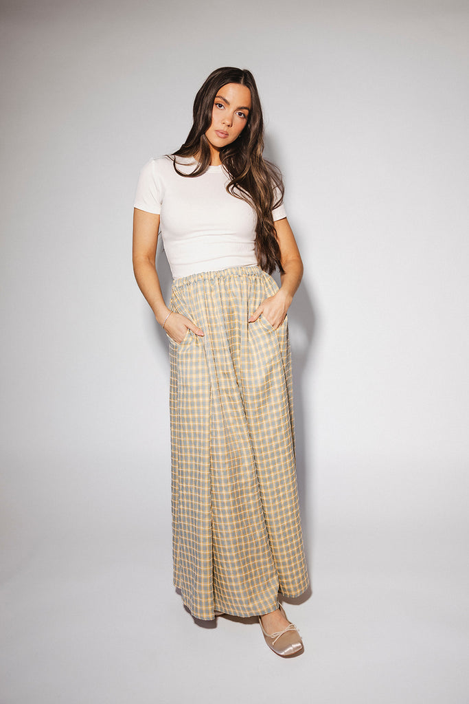 blue and yellow gingham maxi skirt with an elastic waist + side slit details. the perfect flowy gingham skirt to dress up or down for any outfit idea.
